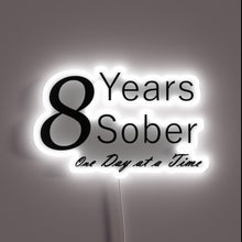 Load image into Gallery viewer, Neon anniversary sign celebrating one year of sobriety milestones daily.
