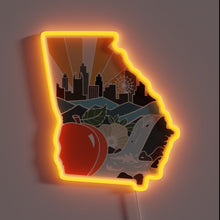Load image into Gallery viewer, Neon sign shaped like Georgia with skyline, peach, and waterfall in orange glow.