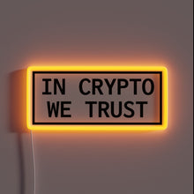 Load image into Gallery viewer, Alt text: "Rectangular neon sign with the phrase 'IN CRYPTO WE TRUST' in bold black capital letters, surrounded by a glowing orange border."