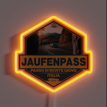 Load image into Gallery viewer, Jaufenpass Italy neon badge with winding road and mountain scene.