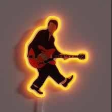 Load image into Gallery viewer, Neon sign of a faceless guitarist in a suit, inspired by Marty McFly's iconic performance with a glowing orange outline.