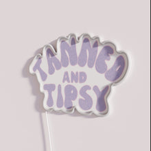 Load image into Gallery viewer, Vibrant purple neon bar decor with tanned tipsy sentiment ambiance.