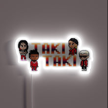 Load image into Gallery viewer, Vibrant Taki Taki logo in colorful RGB neon lighting display.