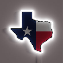 Load image into Gallery viewer, Alt text: "Neon sign in the shape of Texas, filled with the Texas state flag design and glowing with a white border."