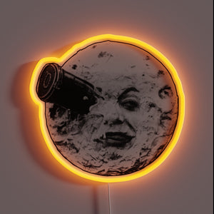 This neon sign features the iconic image from Georges Méliès’ *A Trip to the Moon* (1902), one of the earliest and most influential films in cinema history. The artwork shows the moon with a human face being struck in the eye by a space capsule — a legendary scene symbolizing early cinematic imagination and the birth of science fiction in film.