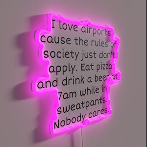 Air travel vibes illuminated in bold, colorful RGB neon letters