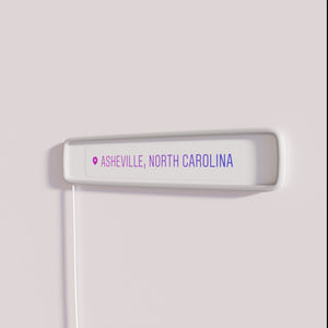 Asheville location marker with vibrant RGB color changing neon signage