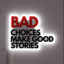 Load image into Gallery viewer, Bold and playful neon sign that reads “**BAD CHOICES MAKE GOOD STORIES**” – striking contrast with red and black text, glowing white border for emphasis. Perfect for a bar, game room, or party spot.