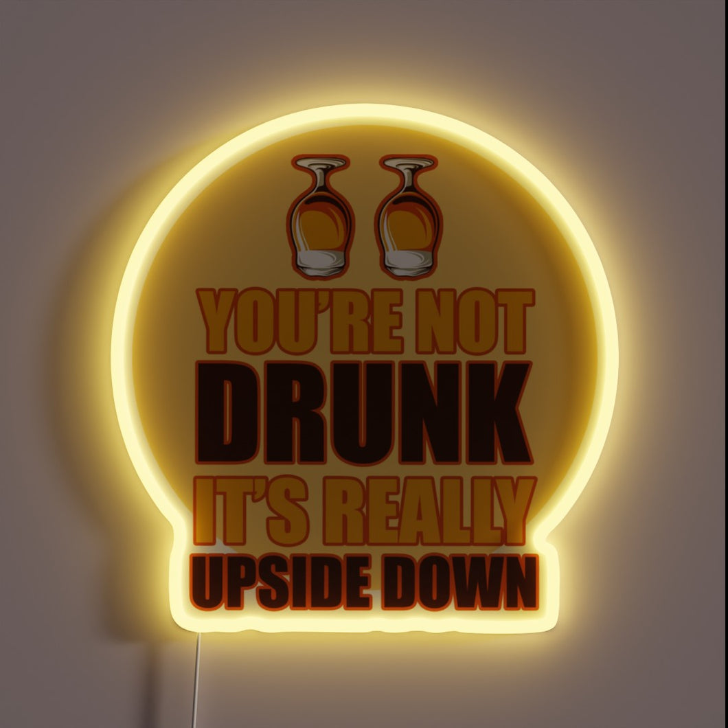 Neon beer sign with upside-down letters in vibrant RGB colors
