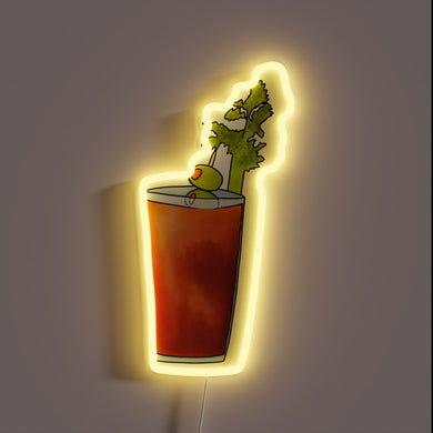 Neon sign shaped like a Bloody Mary cocktail with celery stalk and olive garnish, glowing in yellow.
