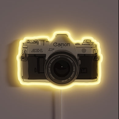 Iconic Canon AE-1 camera in vibrant neon colors against black background.
