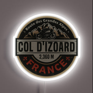Neon sign showcasing **Col d'Izoard** design with motorcycle and mountain graphics — glowing wall decor for alpine riders and French Alps lovers.