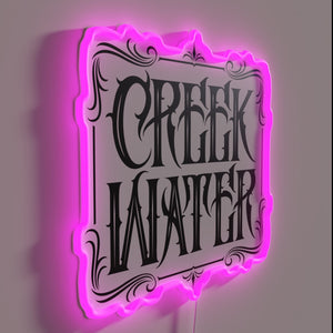 RGB neon whiskey sign with a rustic creek water design