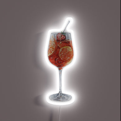 Bright citrusy aperol spritz cocktail garnished with colorful fruit slices