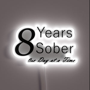 Neon anniversary sign celebrating one year of sobriety milestones daily.