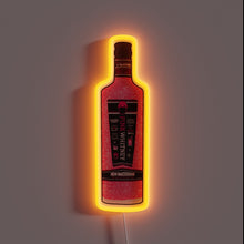 Load image into Gallery viewer, Pink Whitney vodka neon sign with glitter texture and bright orange glow.
