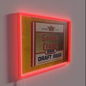 Glowing metallic sign featuring regal golden crown and beer logo