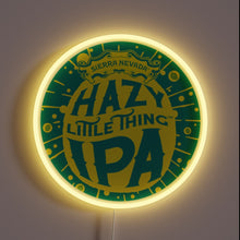 Load image into Gallery viewer, Customneon sign featuring the Hazy Little Thing IPA logo from Sierra Nevada Brewing, with vibrant yellow and green colors surrounded by a glowing yellow neon ring