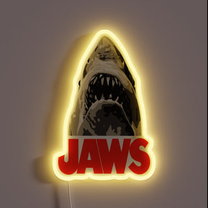 Jaws neon sign with fierce shark and bold red text.