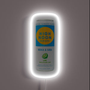 Glowing customneon sign in the shape of a High Noon Sun Sips vodka & soda can