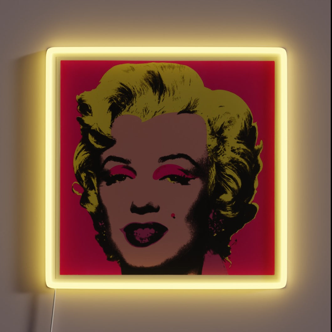 Pop art-style customneon sign of Marilyn Monroe with vibrant yellow hair, pink eye shadow, and red background, framed by a glowing yellow neon square