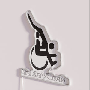 Vibrant Neon Sign Featuring Humorous Wheelchair Meal Delivery Design