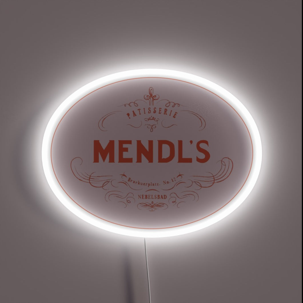 Mendl’s Patisserie neon sign in vintage oval design with glowing white border.