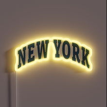 Load image into Gallery viewer, Neon sign of the words “NEW YORK” in arched bold letters with yellow glow.
