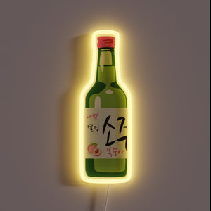 Peach soju bottle with yellow neon glow.
