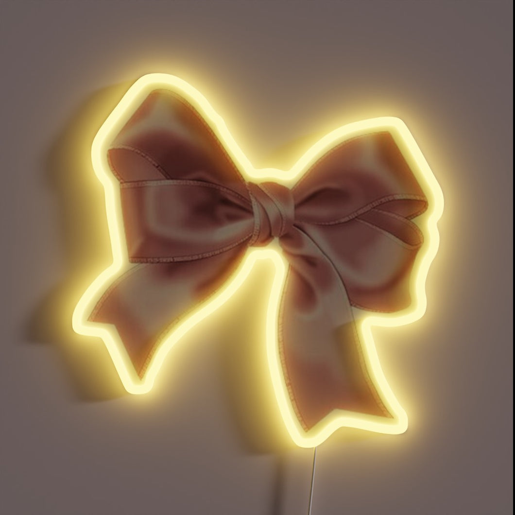 Vibrant pink bow-shaped LED sign with colorful neon effects.