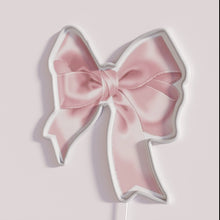 Load image into Gallery viewer, Vibrant pink bow neon sign adds pop to any space
