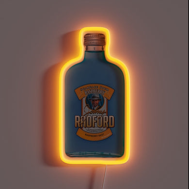 Neon sign shaped like a blue Johnny Radford Raspberry Shot bottle with orange glow.
