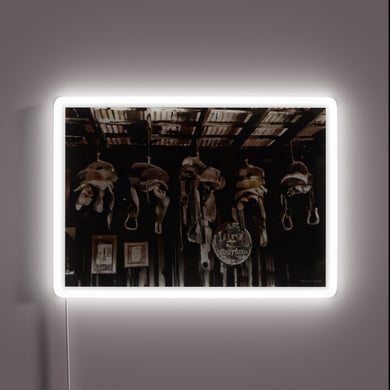 Vibrant LED saddle-shaped neon light adds Western flair to decor spaces.
