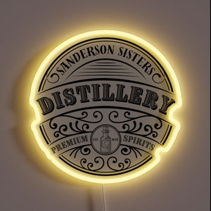 Vibrant RGB glow illuminates Sanderson Sisters Distillery logo with eerie charm.