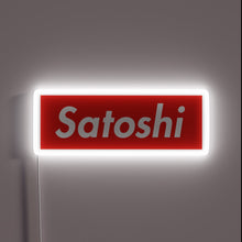 Load image into Gallery viewer, Alt text: &quot;Red neon sign with the word &#39;Satoshi&#39; in white, glowing with a white border.&quot;
