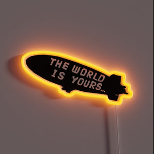This neon sign evokes the iconic blimp message from *Scarface*: **“The World Is Yours…”** — a bold, cinematic reminder to dream big and chase everything. 🛩️🔥
