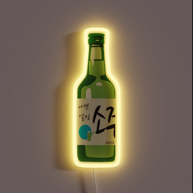 Green soju bottle neon sign with Korean text and a yellow glow.
