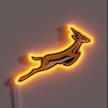 Load image into Gallery viewer, A glowing tribute to speed, agility, and national pride — this Springbok neon sign leaps off the wall with energy. Perfect for rugby fans, South Africans, or anyone who lives fast and bold. 🦌⚡🇿🇦