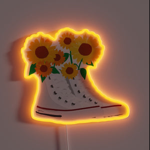 That image brings a perfect mix of retro and nature — classic high-top Chucks overflowing with sunflowers, all outlined in a warm orange neon. 🌻🔥 It gives off a strong indie-artsy vibe, great for a cozy corner or studio wall. Want a caption or product description for this one?