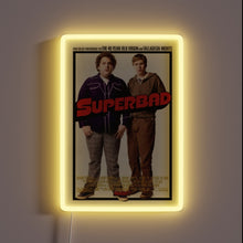 Load image into Gallery viewer, Bring legendary laughs to your wall with this **Superbad** neon-framed poster. 🍻✨ The ultimate tribute to awkward teenage adventures, iconic one-liners, and unforgettable high school nights. Perfect for movie buffs, man caves, or your next party backdrop.