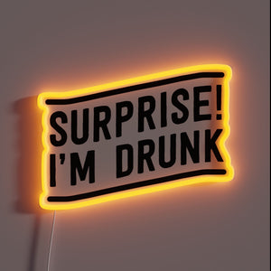 Luminous 'Surprise I'm Drunk' neon sign with vibrant RGB colors