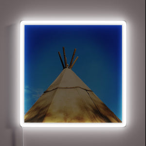Glowing tribal teepee shape illuminated by vibrant RGB neon lights