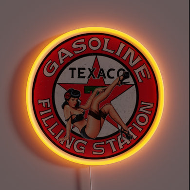 Texaco vintage neon sign with pin-up girl and red glow.