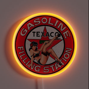Texaco vintage neon sign with pin-up girl and red glow.