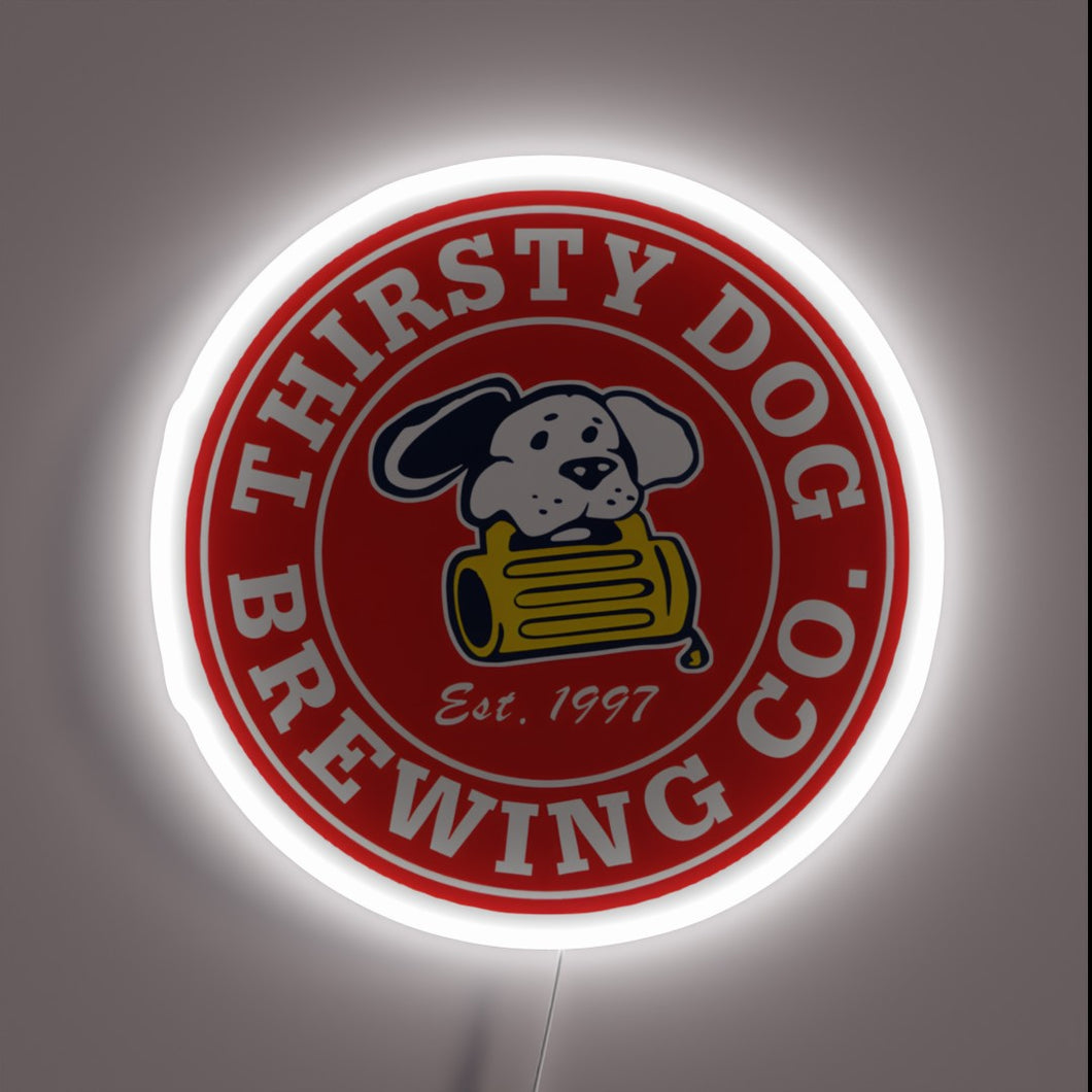 Thirsty Dog Brewing Co. neon sign with cartoon dog and beer barrel.