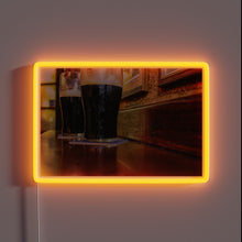 Load image into Gallery viewer, Vibrant RGB lighting illuminates two pints of Guinness in Ireland.