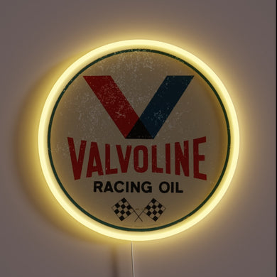 Valvoline racing oil vintage neon sign with yellow glow.