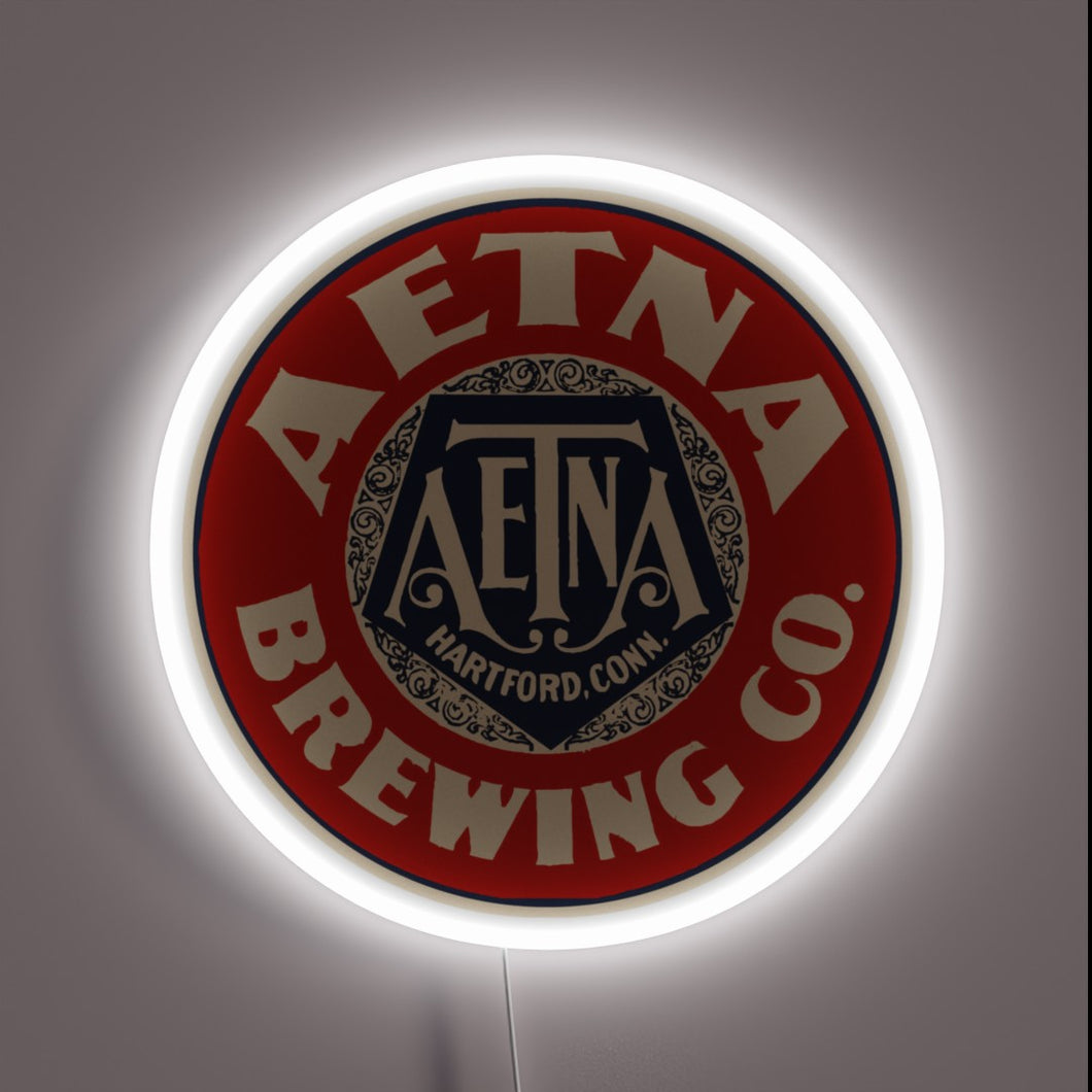 Vintage Aetna Beer advertisement with colorful neon light accents glow.