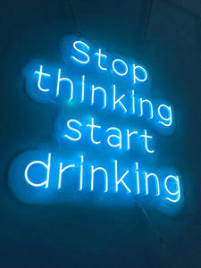 LED neon signs: 'Stop Thinking Start Drinking'